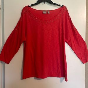 Chicos cotton knit top with brass eyelets at neck edge and down shoulder